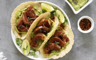 the kitchen doesnt bite shrimp wrapped serrano taco with avocado-cilantro sauce and macha honey